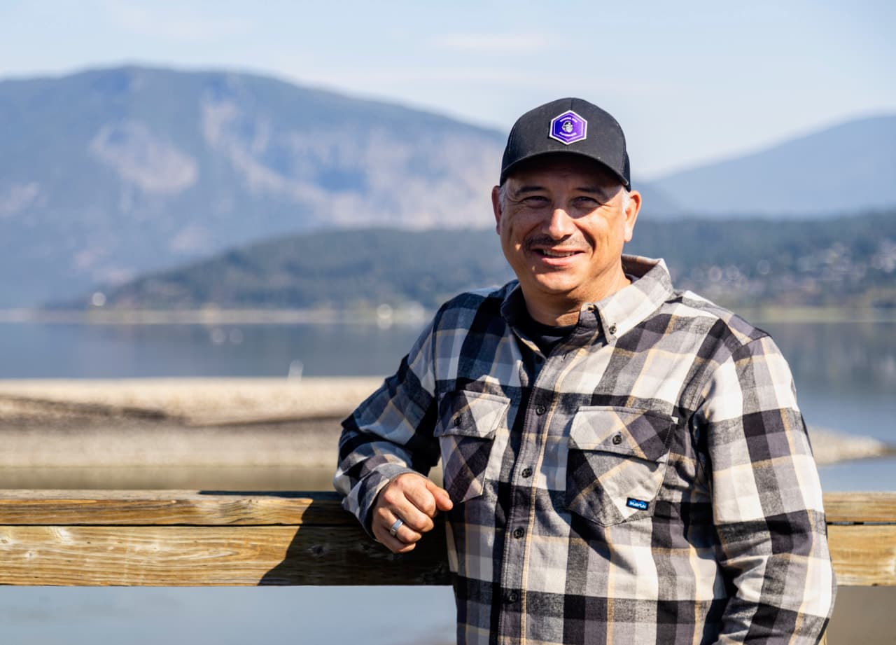 Aaron Canart on the Salmon Arm wharf, Shuswap Lake behind him