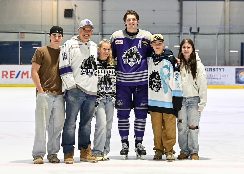Aaron, Brett and their four kids on the ice at the Shaw Centre in Salmon Arm